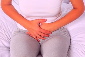 Woman grabbing her abdomen in pain