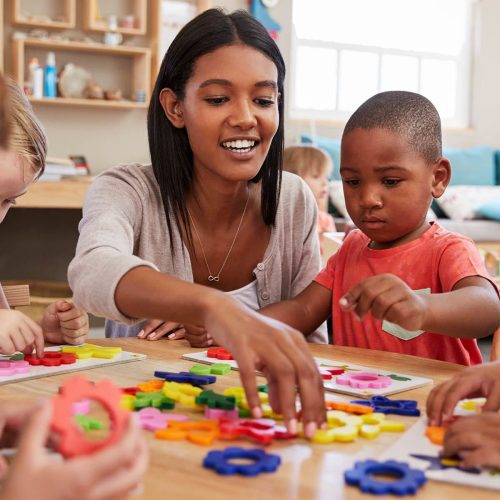 Daycare teacher playing with students
