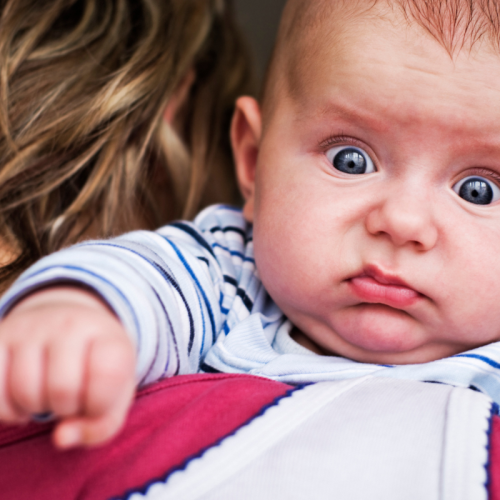 Baby making surprised face, grunting because of gas