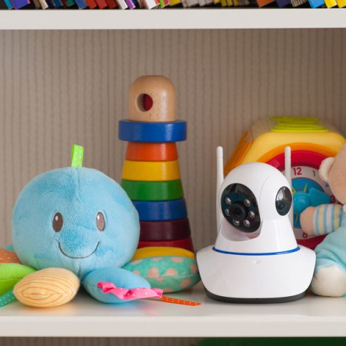 Baby monitor on shelf with toys